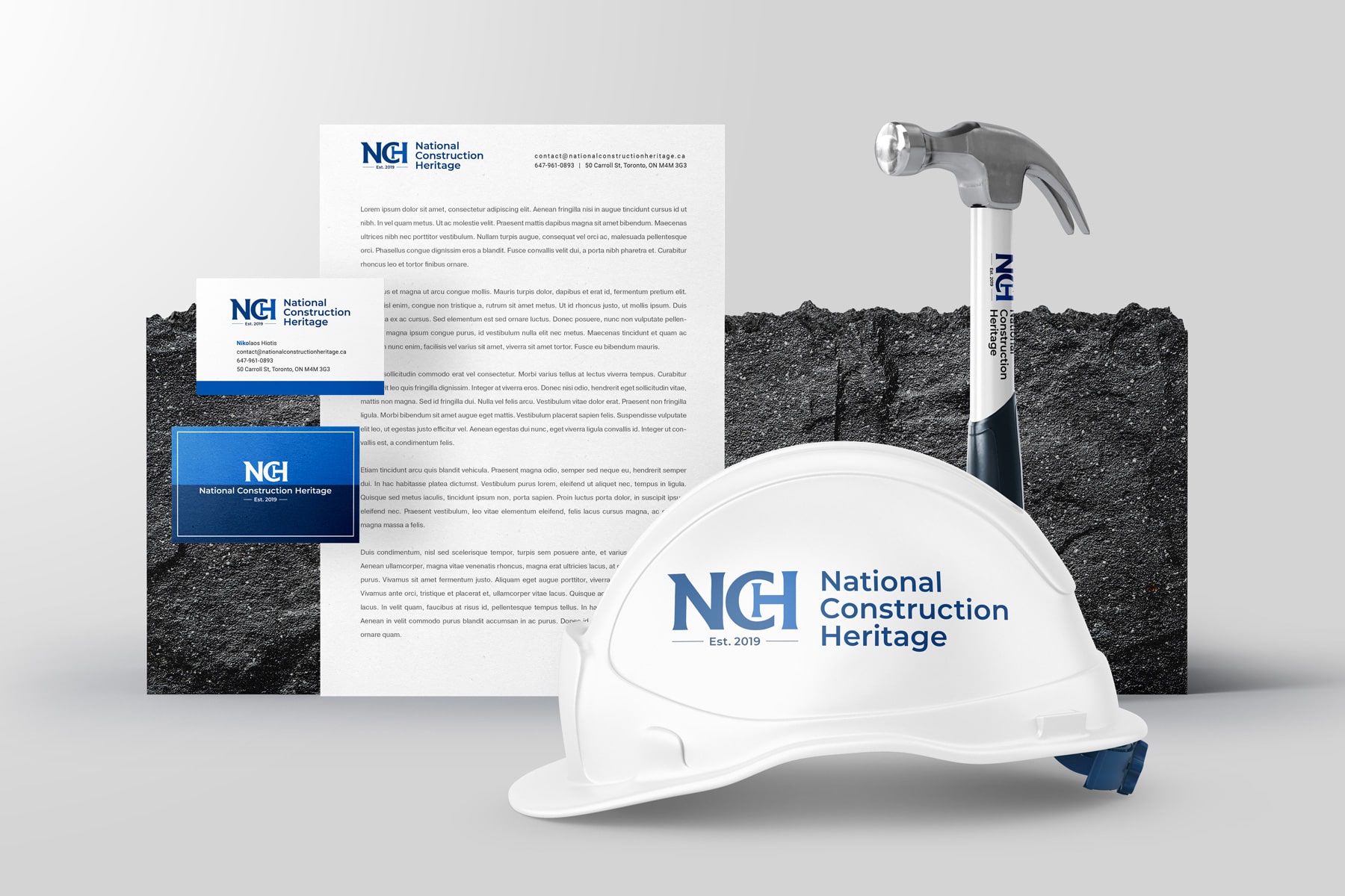 Professional branding materials for National Construction Heritage, featuring a clean logo design on a white hard hat, letterhead, and business cards, exemplifying a polished logo design for building contractors established in 2019.